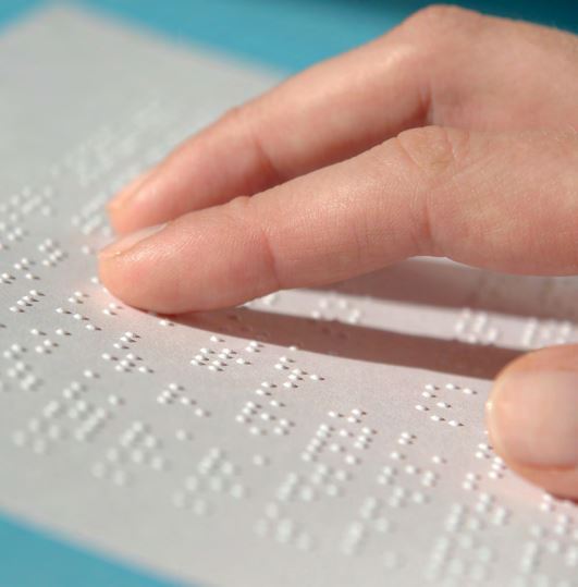 Main lisant un document en braille